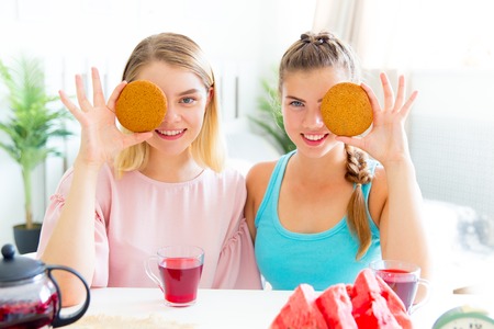 Girls having fun on slumber party eatingの写真素材
