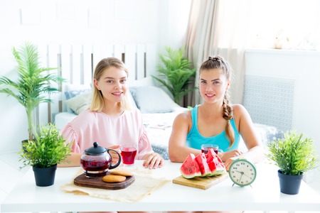 Girls having fun on slumber party eatingの写真素材