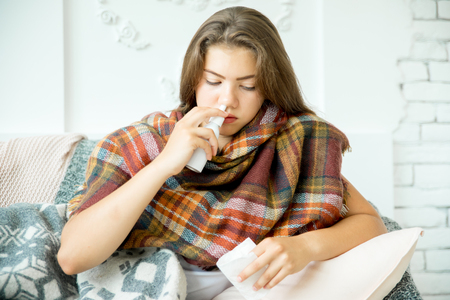 ill young girl with fever spending time at homeの写真素材
