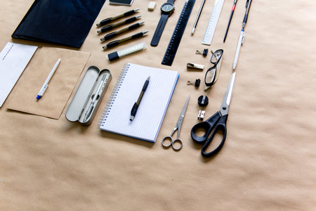 stationery pen scissors notebook on a wooden table