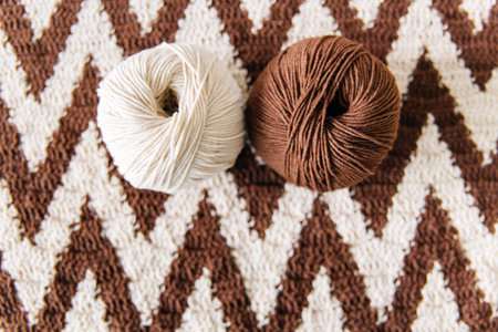 top view of colored yarn balls and knitting needles