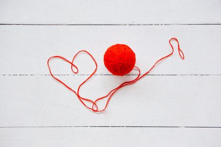 top view of colored yarn balls and knitting needles