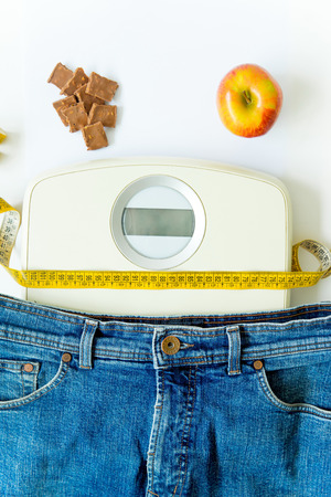 scales and and fruit on a floor, training and healthy lifestyle conceptの写真素材