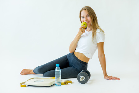 Fit woman measuring waist with measuring tapeの写真素材