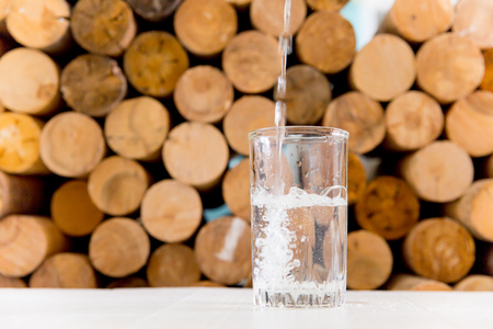 Glass of pure water on a white kitchen tableの写真素材