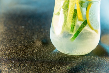 Summer drink coctail in glass jar, berries and mint on wooden tableの写真素材