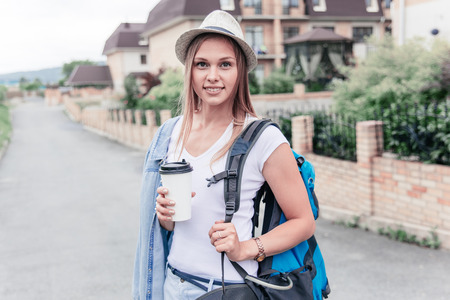 women travelling in a city using map, bags and making photosの写真素材
