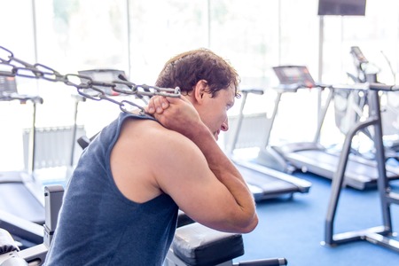 Young muscular man doing crossfit exercises in a gymの写真素材