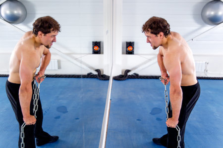 Young muscular man doing crossfit exercises in a gym