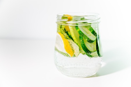 Summer drink coctail in glass jar, berries and mint on wooden tableの写真素材