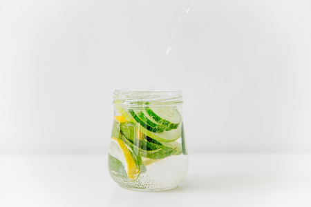 Summer drink coctail in glass jar, berries and mint on wooden tableの写真素材