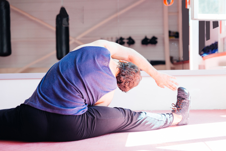 Young muscular man doing crossfit exercises in a gymの写真素材