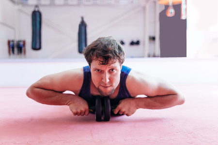 Young muscular man doing crossfit exercises in a gymの写真素材