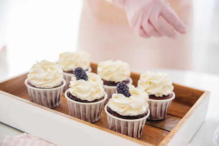 a concept of baking sweet cupcakes and muffins at homeの写真素材