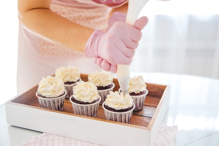 a concept of baking sweet cupcakes and muffins at homeの写真素材