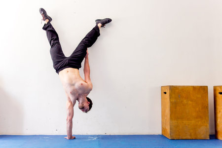 Young muscular man doing crossfit exercises in a gym