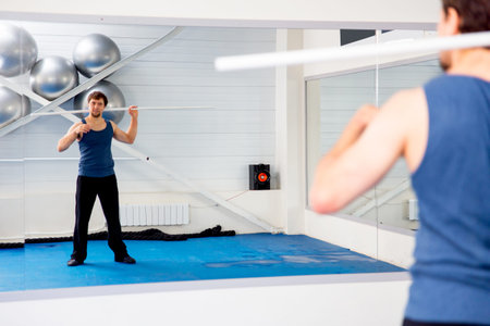 Young muscular man doing crossfit exercises in a gym