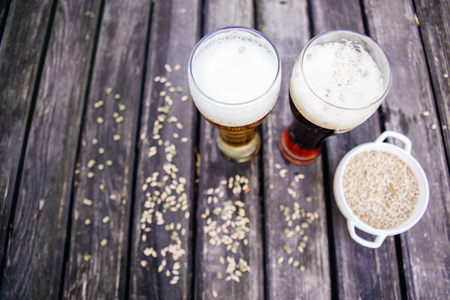 Glass of a tasty home made beer on tableの写真素材