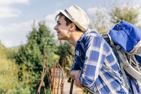 young traveler guy hiking with backpack in the natureの写真素材