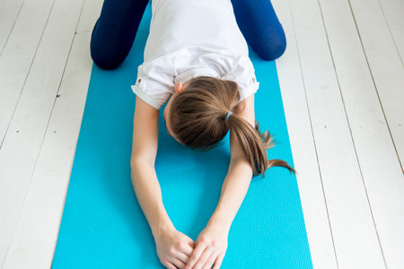 girl doing morning exercises at home. Healthy and sport lifestyle.