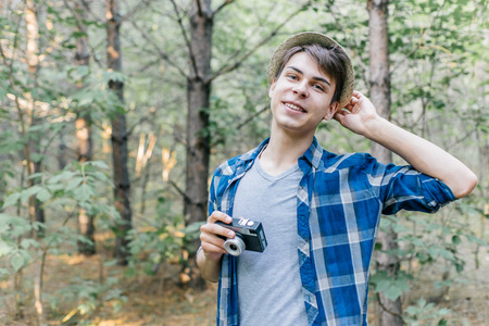 Young man traveler taking a photo in the natureの写真素材