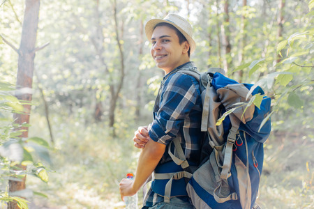 young traveler guy hiking with backpack in the natureの写真素材