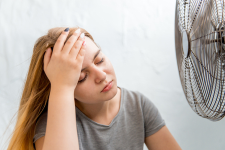 Sick young woman with cold and flu at homeの写真素材
