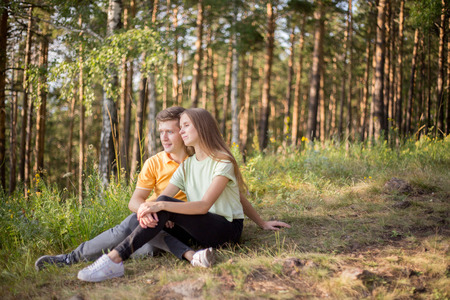 young couple in love walking in the forest togetherの写真素材