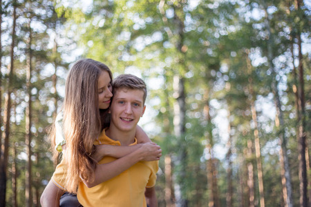 young couple in love walking in the forest togetherの写真素材