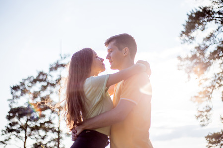 young couple in love walking in the forest togetherの写真素材