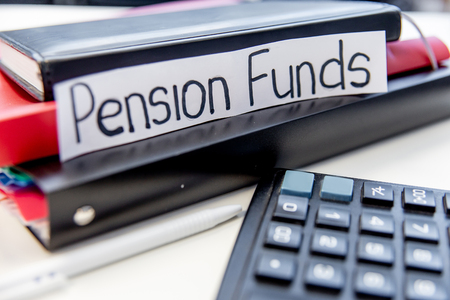 retirement fund concept - money and a calculatorの写真素材