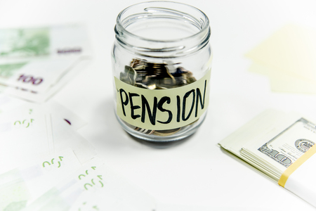 retirement fund concept - money and a calculatorの写真素材