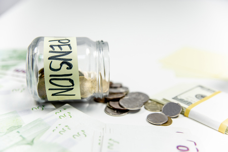 retirement fund concept - money and a calculatorの写真素材