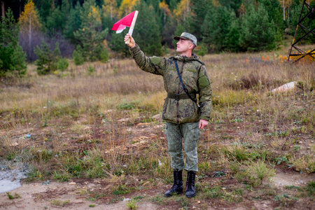 a portrait of a brave soldier standing outsideの写真素材