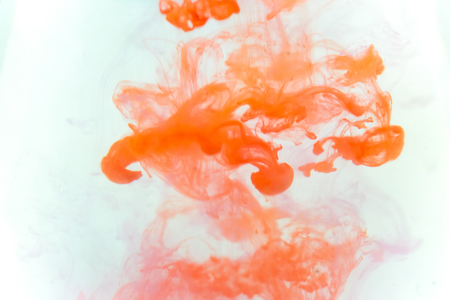 a drop of paint pouring in waterの写真素材