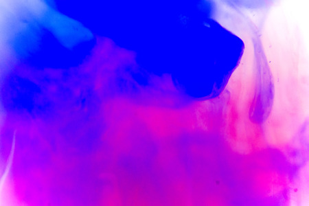 a drop of paint pouring in waterの写真素材