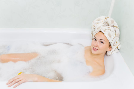 young woman is relaxing in a bathtube