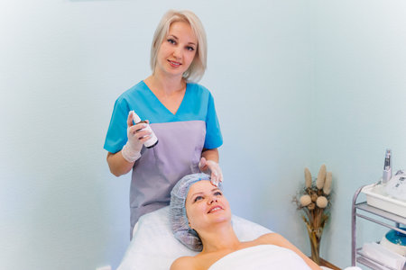 Young pretty woman enjoying a facial mask procedure
