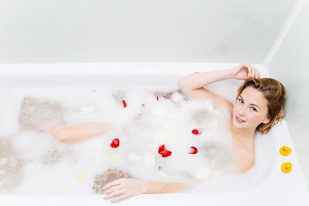 young woman is relaxing in a bathtubeの写真素材
