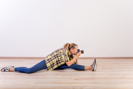 different photographer poses: bending, squatting, lying downの写真素材