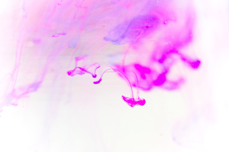 a drop of paint pouring in waterの写真素材