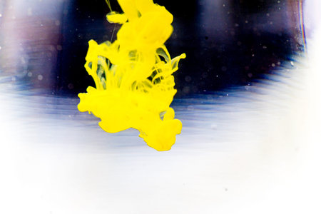 a drop of paint pouring in waterの写真素材