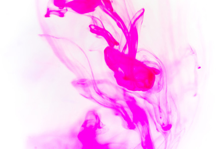 a drop of paint pouring in waterの写真素材