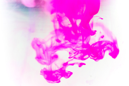 a drop of paint pouring in waterの写真素材