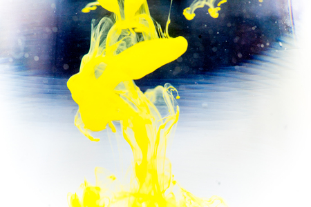 a drop of paint pouring in waterの写真素材