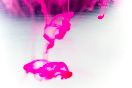 a drop of paint pouring in waterの写真素材