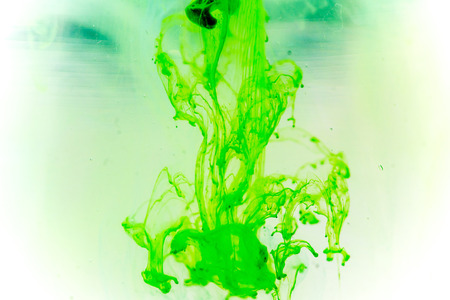 a drop of paint pouring in waterの写真素材