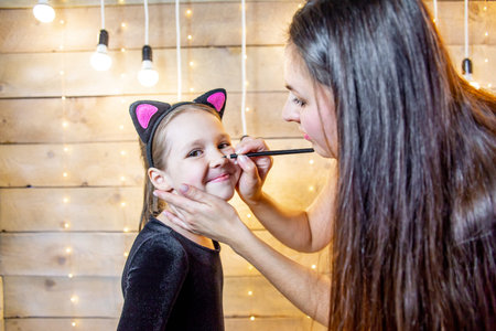 Mother and her daughter preparing halloween costumes