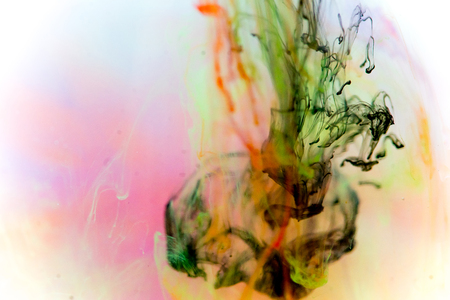 a drop of paint pouring in waterの写真素材