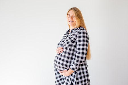 pregnant woman standing on scales to control weight gainの写真素材